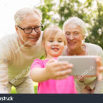 stock-photo-family-generation-and-people-concept-happy-smiling-grandmother-grandfather-and-little-747872989