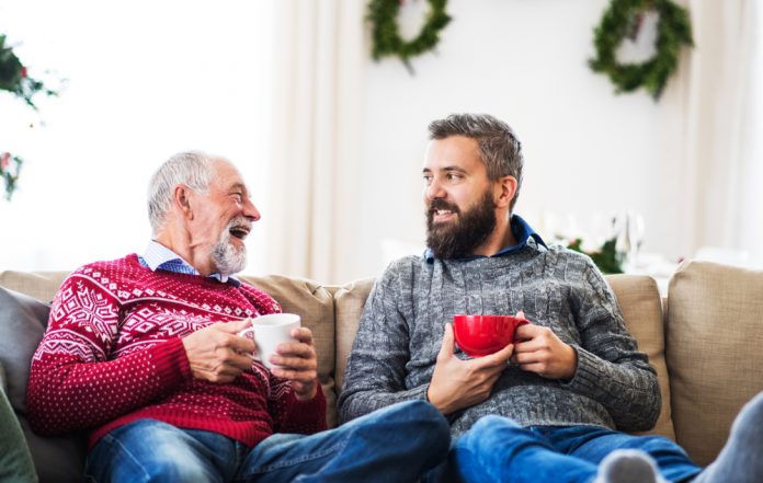 dad and son spending time together on the couch during the holidays